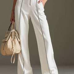 White cotton blend short sleeve wide-leg jumpsuit for women, featuring a relaxed fit and stylish design.
