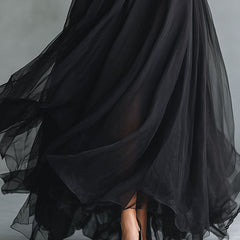 Elegant black tulle maxi dress with patchwork design, fitted knit silhouette, flowing style, perfect for formal occasions.