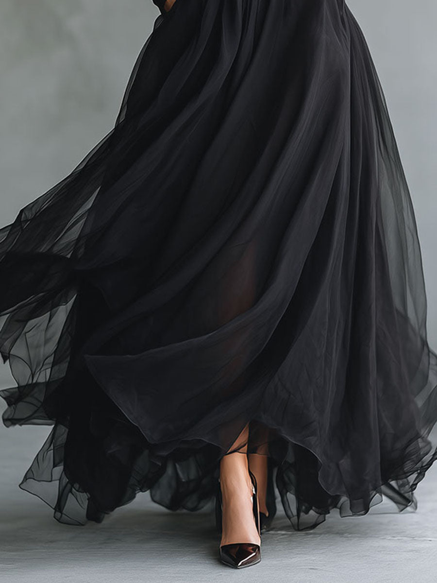 Elegant black tulle maxi dress with patchwork design, fitted knit silhouette, flowing style, perfect for formal occasions.
