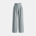 White high-waisted pleated wide-leg trousers for women by Tammy Bradley, shown on a model, with a relaxed fit and flowing fabric.