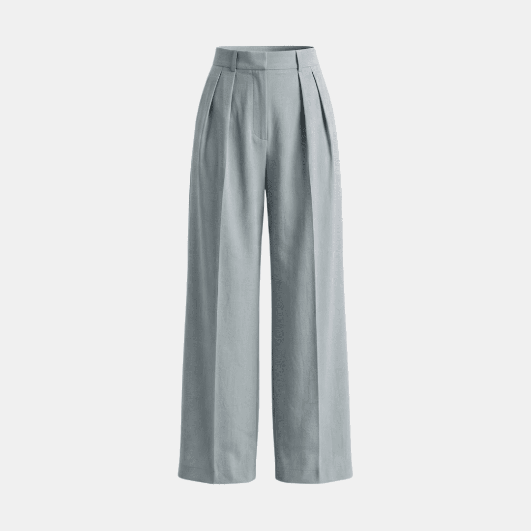 White high-waisted pleated wide-leg trousers for women by Tammy Bradley, shown on a model, with a relaxed fit and flowing fabric.