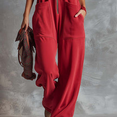 Raspberry red cotton hooded zip-front jumpsuit for women, featuring a comfortable fit and stylish design.