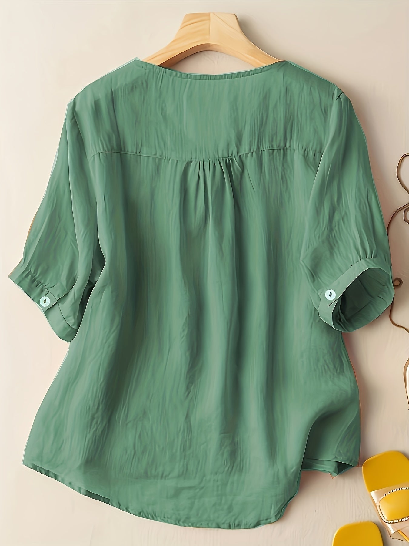Light beige V-neck linen summer blouse for women, featuring a flowy and casual design, perfect for warm weather.
