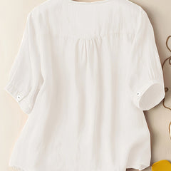 Light beige V-neck linen summer blouse for women, flowy and casual, perfect for warm weather and relaxed style.