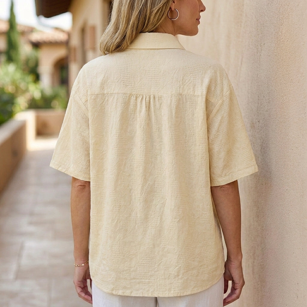 Back view of a floral short sleeve denim summer blouse for women, featuring a casual and stylish design.