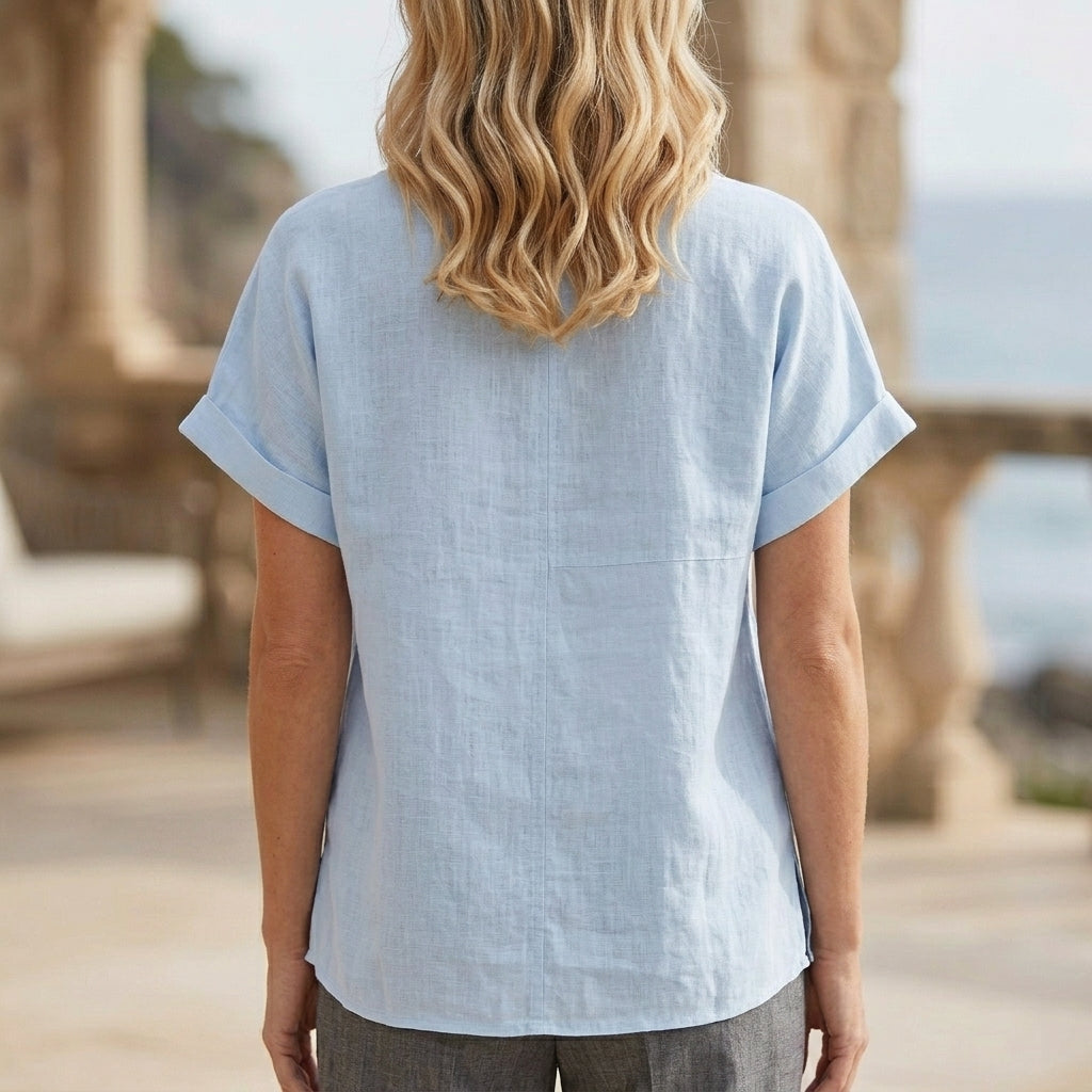 Back view of a women's summer denim blouse with V-neck and short sleeves, featuring casual and stylish design.