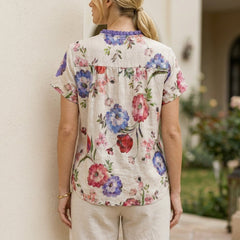 Back view of a floral summer blouse for women with short sleeves, featuring a relaxed fit and lightweight fabric.