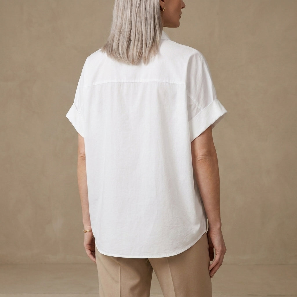 Back view of a women's summer denim blouse with short sleeves and wide-leg fit, featuring a relaxed, casual style.