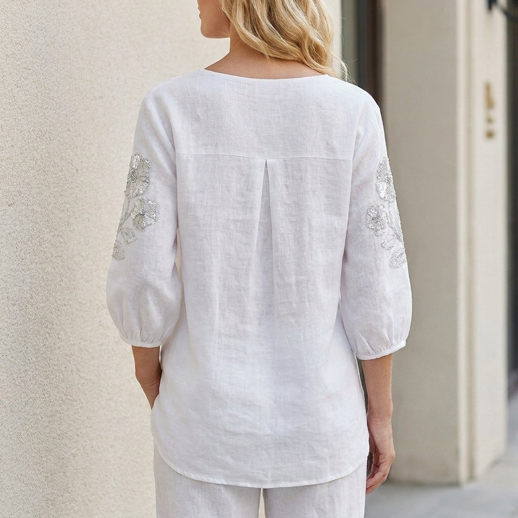 Floral summer blouse for women with puff sleeves, shown from the back, stylish and lightweight top in soft fabric.