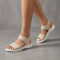 Beige knit ankle-strap sandals for women by Tammy Bradley, featuring open toes and stylish ankle straps.