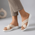 Beige women's criss-cross knit slide sandals by Tammy Bradley showing the stylish open-toe design and comfortable slip-on style.