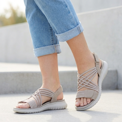 Beige orthopedic criss-cross strappy sandals for women with adjustable straps and cushioned soles.