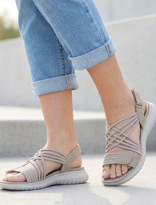 Beige orthopedic criss-cross strappy sandals for women with adjustable straps and cushioned soles.