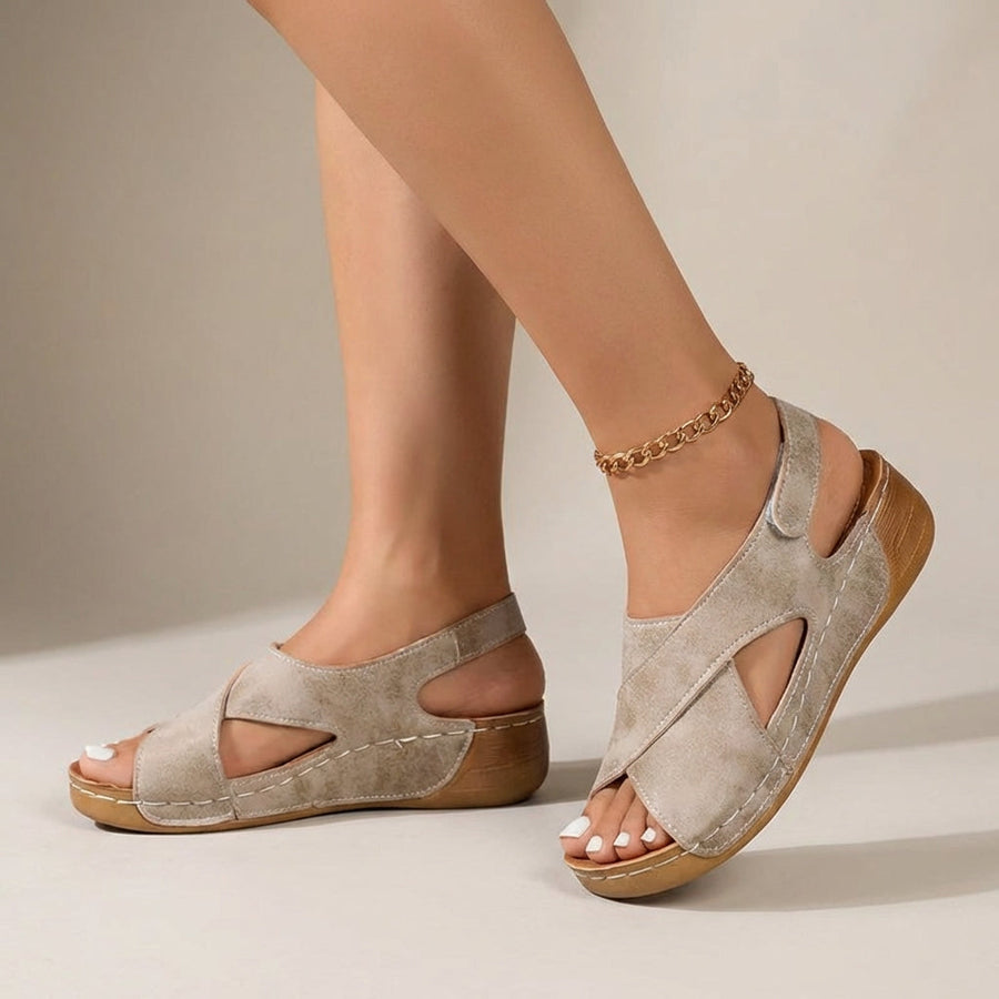 Beige orthopedic criss-cross slingback wedge sandals for women with supportive straps and chunky heels.