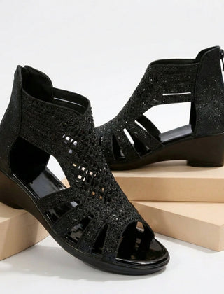 Black women's orthopedic heeled sandals with wedge heel and cut-out design, stylish and supportive footwear.