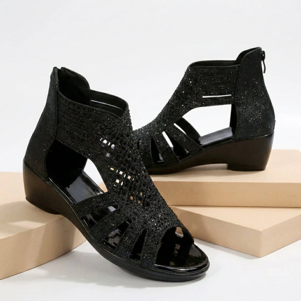 Black women's orthopedic heeled sandals with wedge heel and cut-out design, stylish and supportive footwear.
