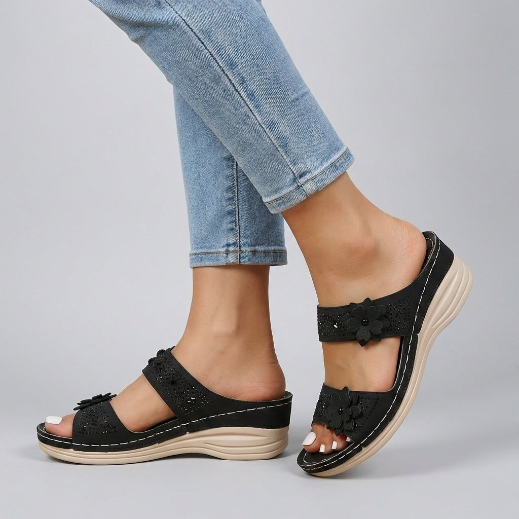 Black floral strap wedge heeled sandals for women by Tammy Bradley, featuring a stylish design and comfortable heel height.