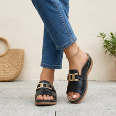 Black orthopedic slide sandals with buckle detail and contrast stitching, designed for comfort and support.