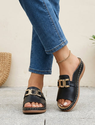 Black orthopedic slide sandals with buckle detail and contrast stitching, designed for comfort and support.