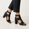 Black women's cut-out block-heel sandals with ankle buckle by Tammy Bradley, showcasing stylish open design and sturdy heel.