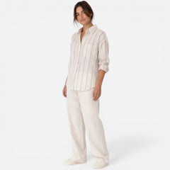 Women's striped button-down shirt with relaxed fit and lightweight fabric, featuring vertical stripes and a classic collar.
