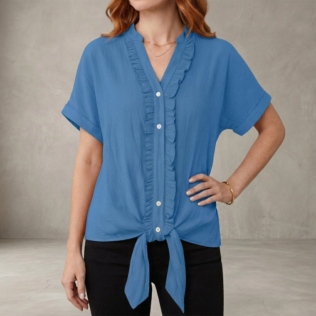 Blue V-neck denim summer blouse for women with ruffle details, casual style, perfect for warm weather.