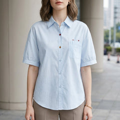 Blue women's summer blouse with puff sleeves, denim fabric, button front, casual style, perfect for warm weather.