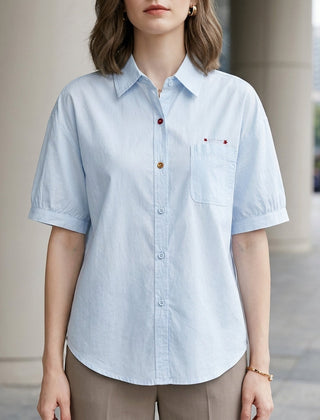 Blue women's summer blouse with puff sleeves, denim fabric, button front, casual style, perfect for warm weather.