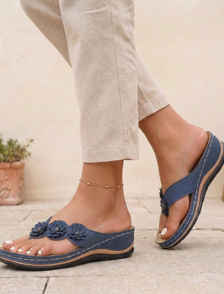 Blue floral appliqué wedge thong sandals for women by Tammy Bradley, featuring decorative flower details and comfortable wedge heel.