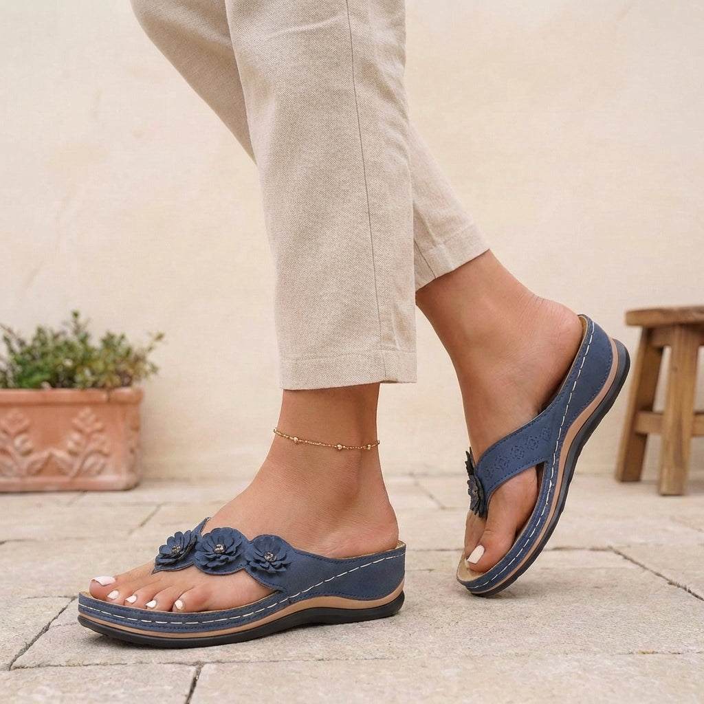Blue floral appliqué wedge thong sandals for women by Tammy Bradley, featuring decorative flower details and comfortable wedge heel.