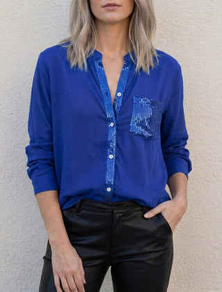 Blue denim women's summer blouse with V-neck and button front, casual top for warm weather.