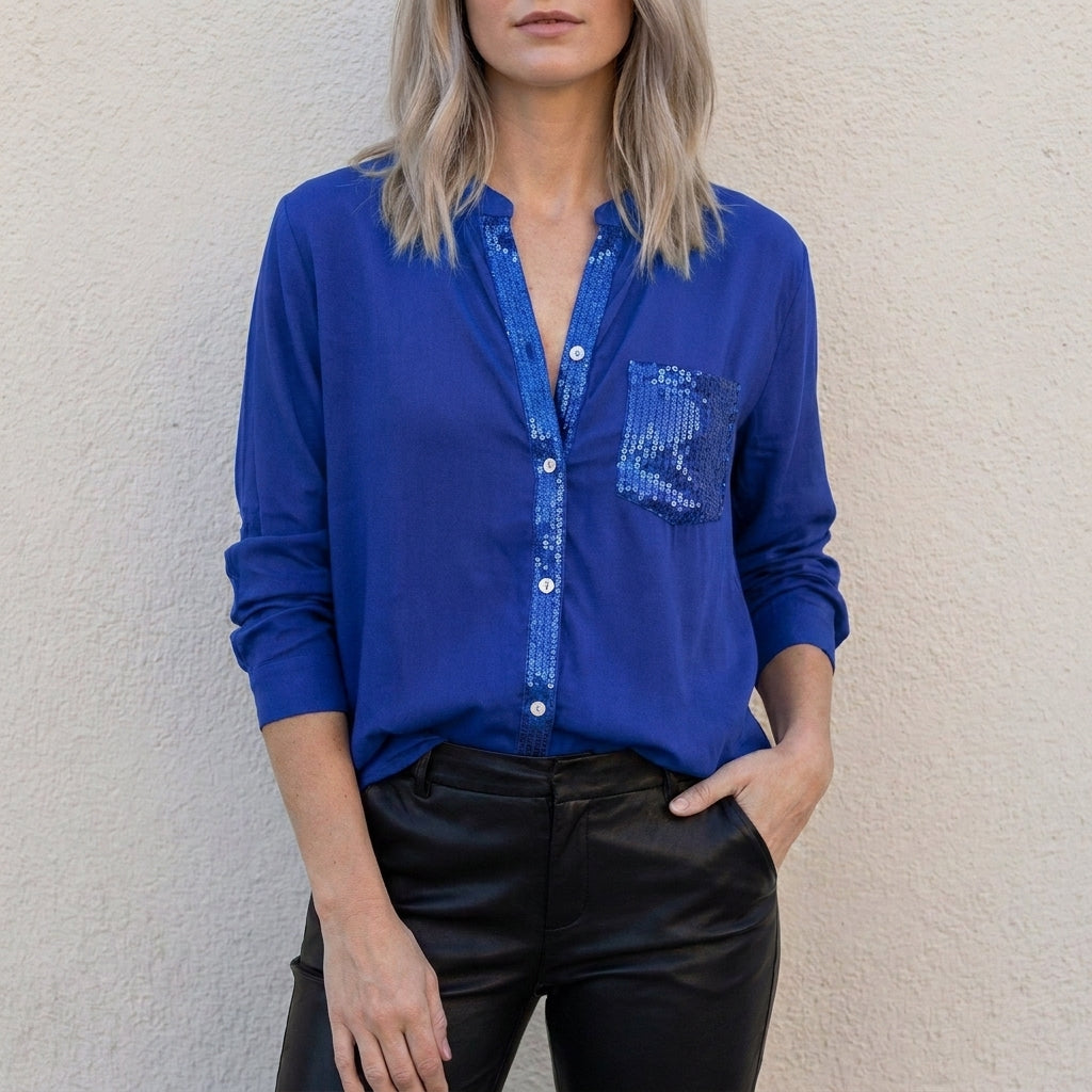Blue denim women's summer blouse with V-neck and button front, casual top for warm weather.