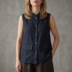 Blue sleeveless denim summer blouse for women with button front, stylish top perfect for casual warm-weather outfits.