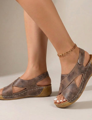Brown orthopedic criss-cross slingback wedge sandals for women with supportive straps and comfortable design.