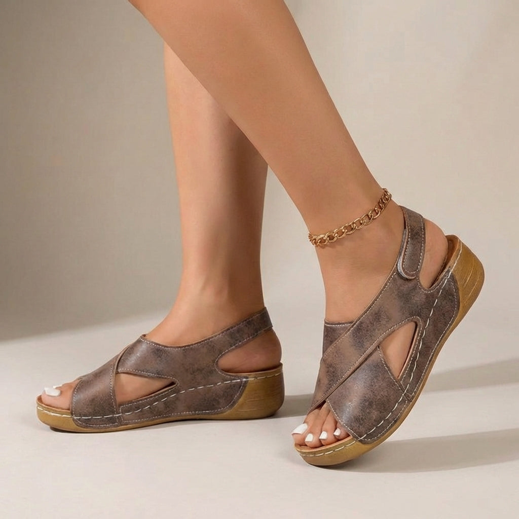 Brown orthopedic criss-cross slingback wedge sandals for women with supportive straps and comfortable design.