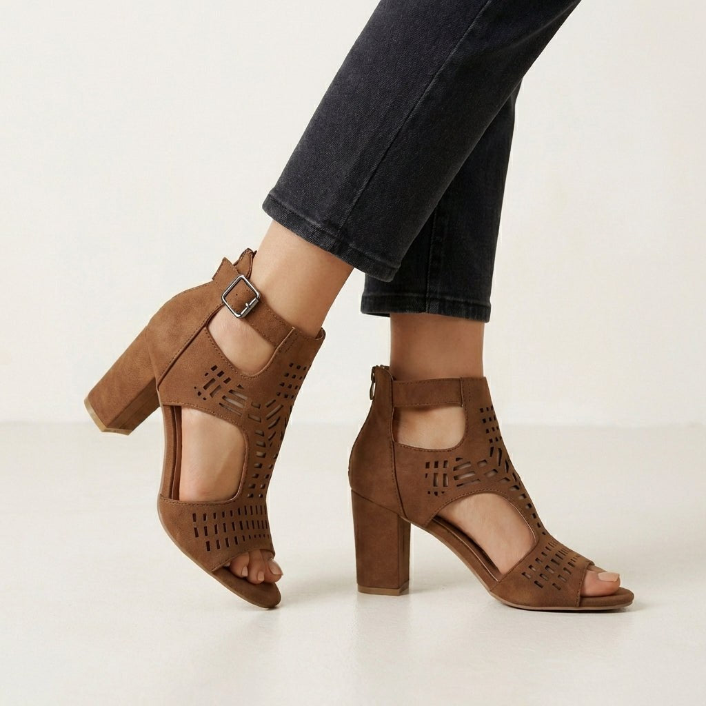 Brown women's cut-out block-heel sandals with ankle buckle by Tammy Bradley, showcasing stylish open-toe design and chunky heel.