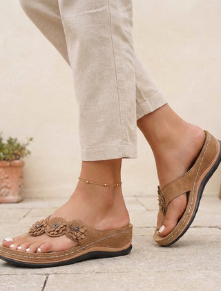 Brown floral appliqué wedge thong sandals for women by Tammy Bradley, featuring decorative flower details and comfortable wedge heel.