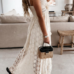 White lace strappy long dress with resort style design, featuring intricate details and flowing fabric, perfect for elegant occasions.