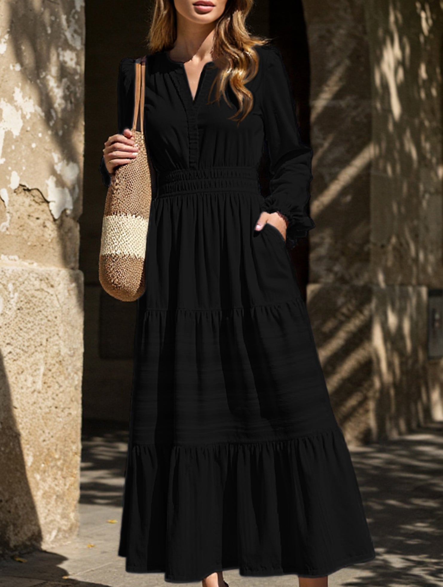 Black V-neck pleated waist tiered long-sleeved dress with a flowing silhouette, featuring a stylish design suitable for various occasions.