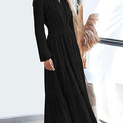 Black V-neck pleated waist tiered long-sleeved dress with a flowing silhouette, perfect for elegant occasions.