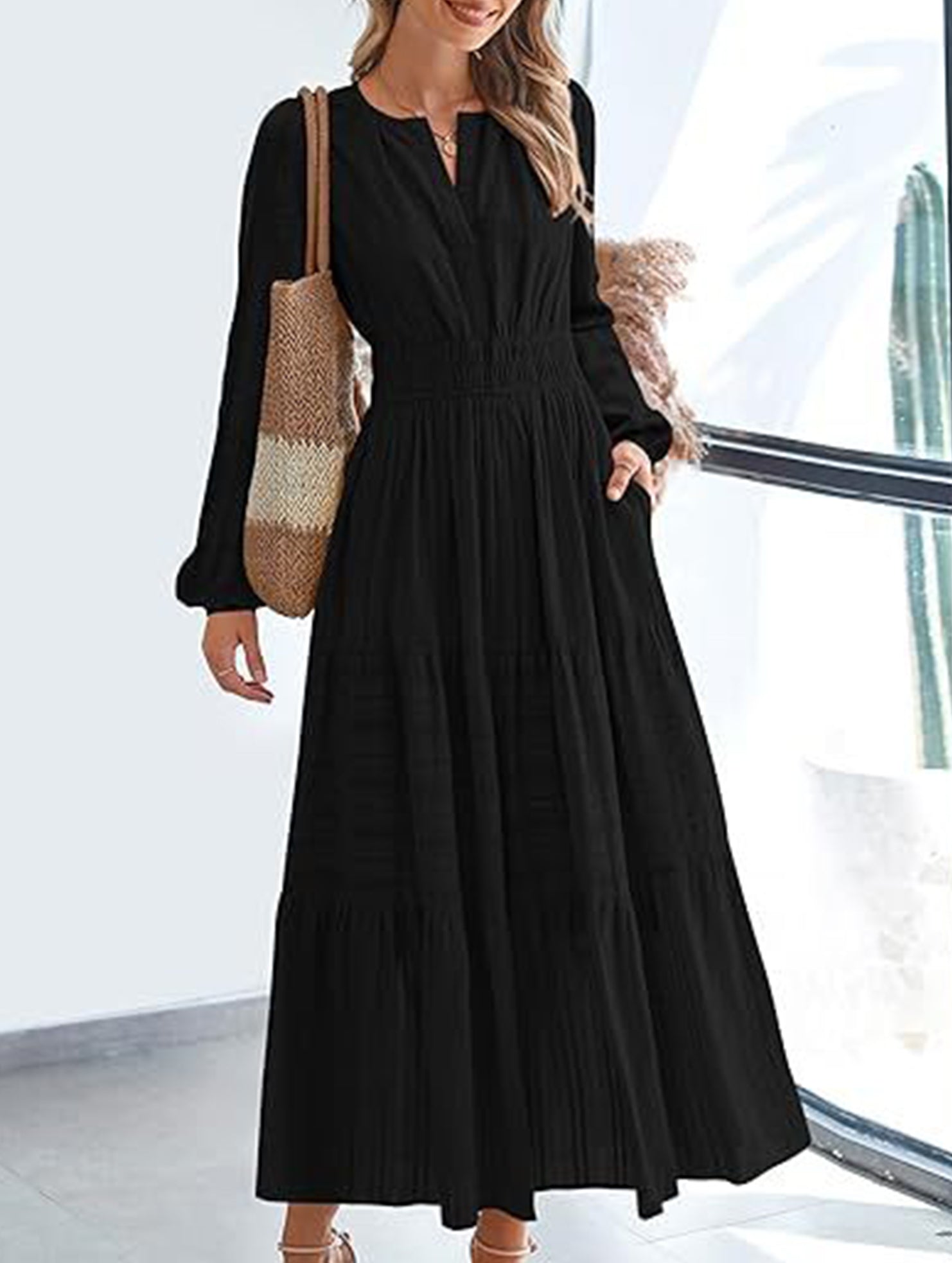 Black V-neck pleated waist tiered long-sleeved dress, stylish and elegant, featuring a flattering silhouette and flowing fabric.
