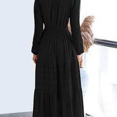 Black V-neck pleated waist tiered long-sleeved dress with a flowing design, featuring a stylish tiered skirt and elegant long sleeves.