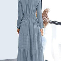 Blue-grey V-neck pleated waist tiered long-sleeved dress with a flowing silhouette, stylish and elegant for women.