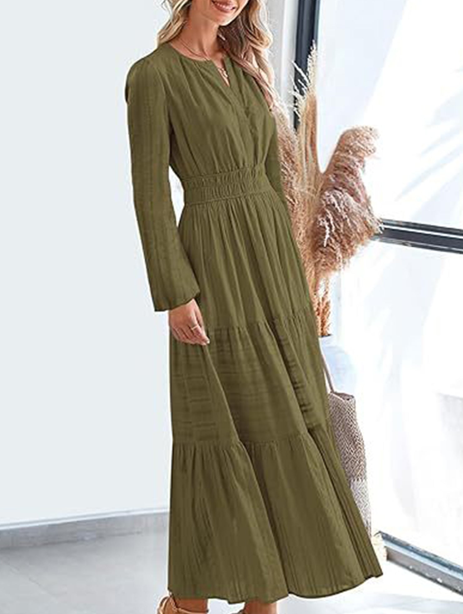 White V-neck pleated waist tiered long-sleeve dress with a flowing silhouette, featuring elegant pleats and tiered design.