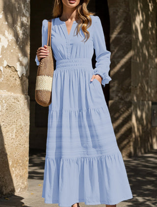 Light blue V-neck pleated waist tiered long-sleeved dress with flowing fabric and tiered hem, stylish and elegant for various occasions.