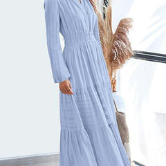 Light blue V-neck pleated waist tiered long-sleeved dress with a flowy silhouette, featuring a stylish and elegant design.