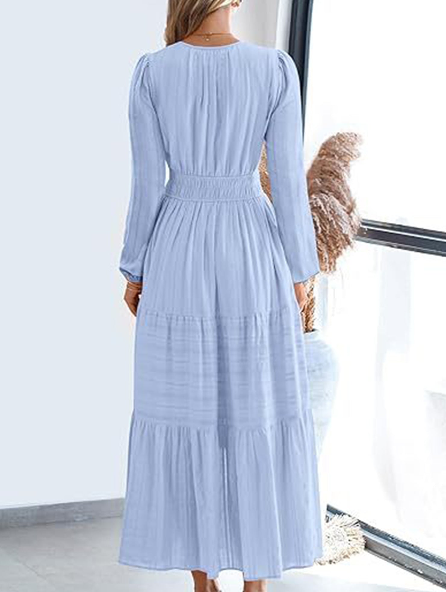 Light blue V-neck pleated waist tiered long-sleeved dress with a flowing silhouette, stylish and elegant for any occasion.
