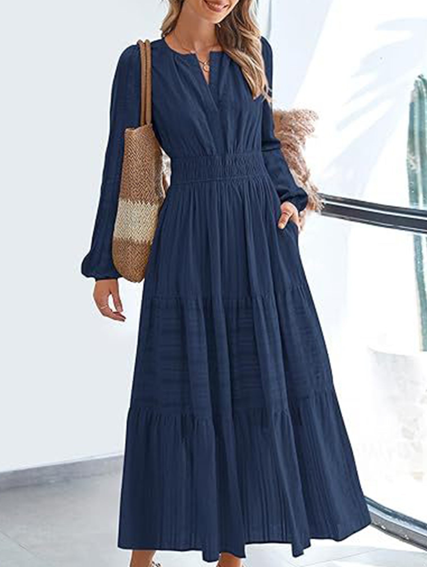 Navy V-neck pleated waist tiered long-sleeved dress with flowy layers and elegant design, perfect for stylish occasions.