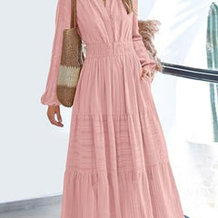 White V-neck pleated waist tiered long-sleeved dress with a flowy silhouette and feminine design.