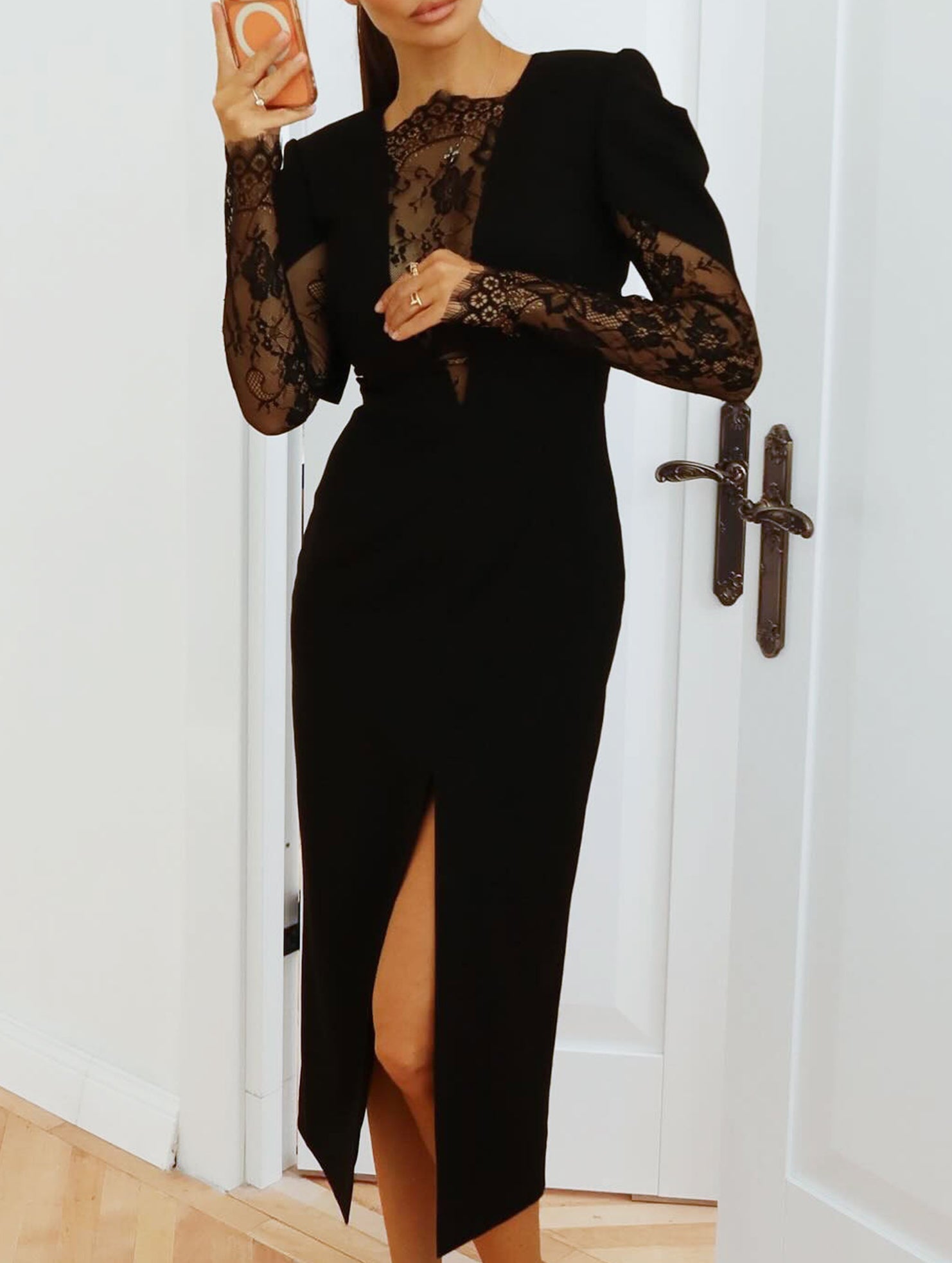 Black openwork dress with lace slit and cinched waist by Tammy Bradley, featuring intricate lace details and elegant design.
